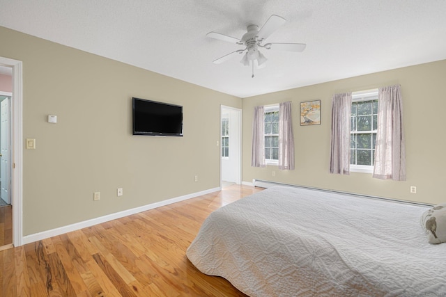 58 Snake Meadow Rd, Killingly, CT 06239 - bedroom featuring light wood-style flooring, baseboard heating, baseboards, and a ceiling fan