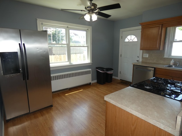 450 Thorme St, Bridgeport, CT 06606 - kitchen with radiator, appliances with stainless steel finishes, a ceiling fan, light wood finished floors, and light countertops