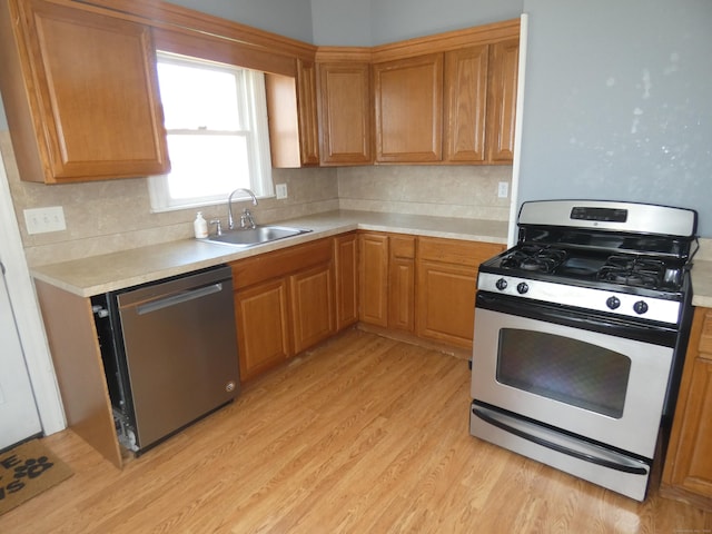 450 Thorme St, Bridgeport, CT 06606 - kitchen with stainless steel appliances, a sink, light countertops, and decorative backsplash