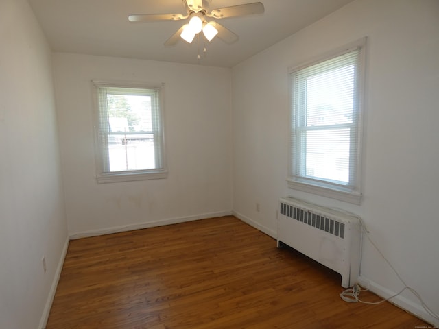 450 Thorme St, Bridgeport, CT 06606 - spare room with radiator heating unit, wood finished floors, ceiling fan, and baseboards