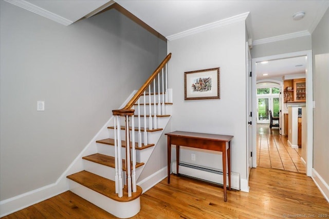 11 Wendover Rd, Newtown, CT 06470 - stairway with a baseboard heating unit, wood finished floors, crown molding, and baseboards