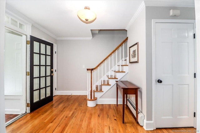 11 Wendover Rd, Newtown, CT 06470 - entrance foyer featuring a baseboard heating unit, light wood finished floors, crown molding, stairs, and baseboards