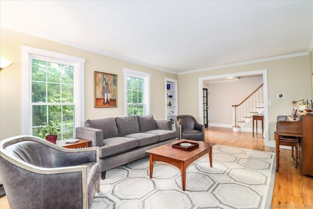 11 Wendover Rd, Newtown, CT 06470 - living room featuring light wood finished floors, crown molding, plenty of natural light, stairs, and built in shelves