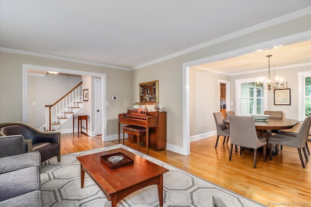 11 Wendover Rd, Newtown, CT 06470 - living area with light wood finished floors, a chandelier, stairs, baseboards, and ornamental molding