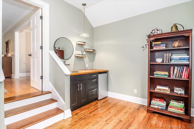 11 Wendover Rd, Newtown, CT 06470 - bar area featuring light wood finished floors, refrigerator, baseboards, decorative light fixtures, and vaulted ceiling