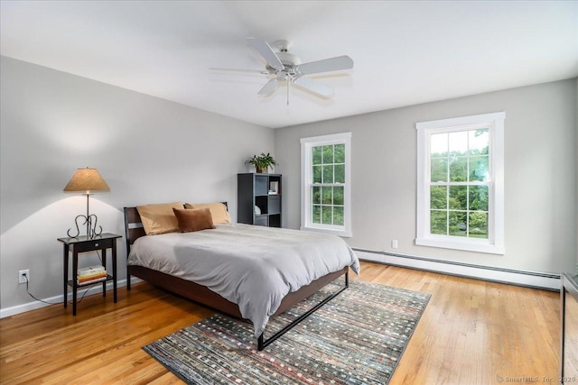 11 Wendover Rd, Newtown, CT 06470 - bedroom with a baseboard radiator, wood finished floors, baseboards, and ceiling fan