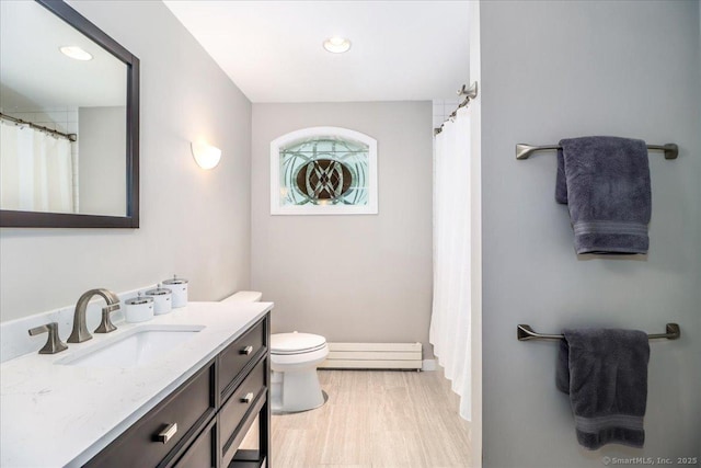 11 Wendover Rd, Newtown, CT 06470 - full bathroom with a baseboard heating unit, vanity, toilet, wood finished floors, and recessed lighting