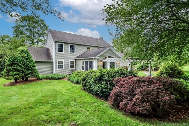 11 Wendover Rd, Newtown, CT 06470 - back of property with a pergola, a lawn, and a shingled roof