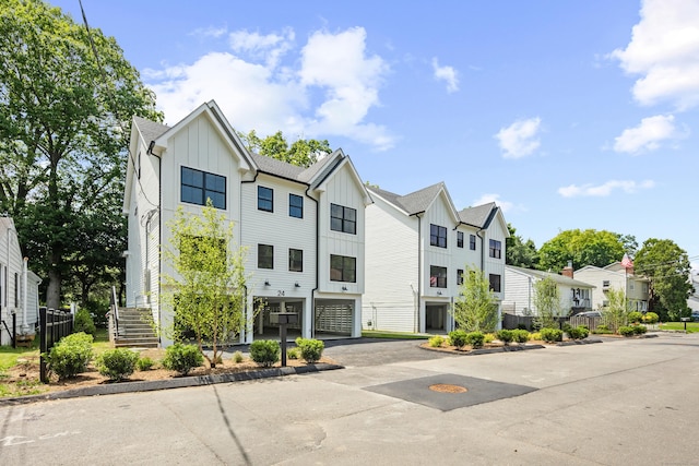 26 Homestead Ln Unit B, Greenwich, CT 06831 - view of property with a residential view, asphalt driveway, stairs, and a garage
