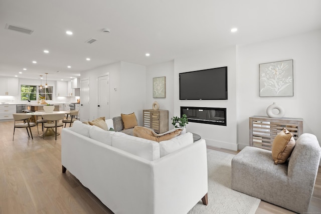 26 Homestead Ln Unit B, Greenwich, CT 06831 - living room with light wood-style flooring, recessed lighting, and a glass covered fireplace