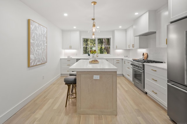 26 Homestead Ln Unit B, Greenwich, CT 06831 - kitchen featuring stainless steel appliances, custom exhaust hood, a center island, a kitchen breakfast bar, and light wood finished floors