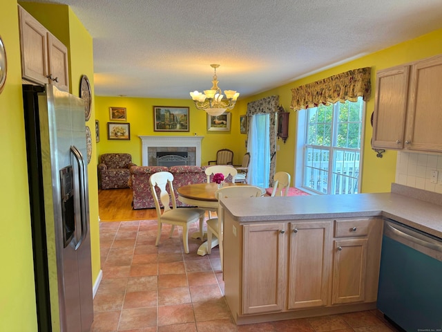 29 Swift St, Branford, CT 06405 - kitchen with dishwashing machine, stainless steel refrigerator with ice dispenser, open floor plan, a chandelier, and a peninsula