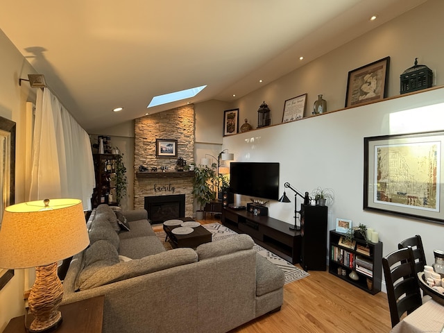 20 Marlin Rd, New Britain, CT 06053 - living room featuring a skylight, a stone fireplace, light wood-style flooring, lofted ceiling, and recessed lighting