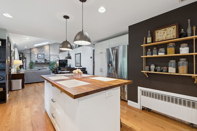 20 Marlin Rd, New Britain, CT 06053 - kitchen featuring butcher block countertops, radiator heating unit, stainless steel fridge with ice dispenser, white cabinets, and light wood finished floors
