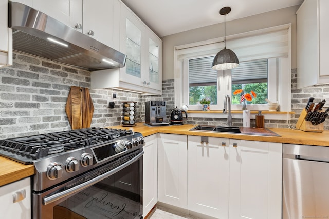 20 Marlin Rd, New Britain, CT 06053 - kitchen featuring stainless steel appliances, wooden counters, under cabinet range hood, a sink, and decorative backsplash