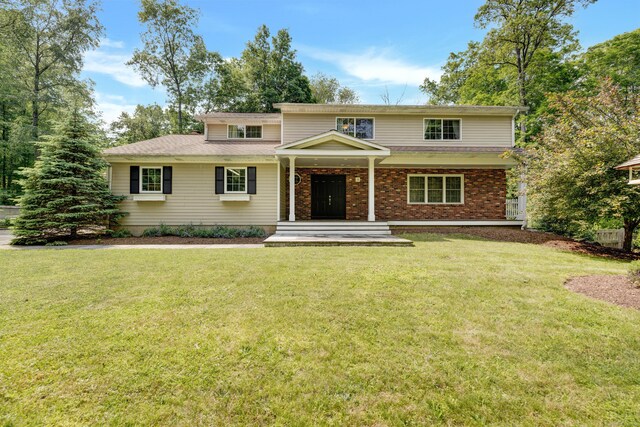 19 Maplecrest Dr, Danbury, CT 06811 - traditional-style house featuring a front lawn, covered porch, and roof with shingles