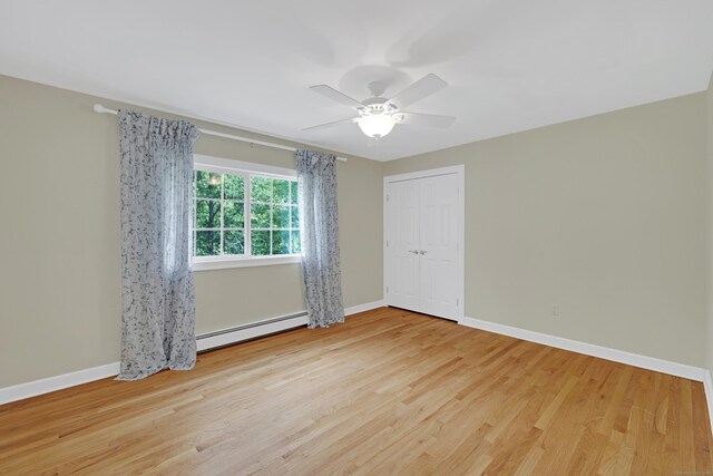 19 Maplecrest Dr, Danbury, CT 06811 - unfurnished room with a baseboard heating unit, ceiling fan, and light wood-style floors