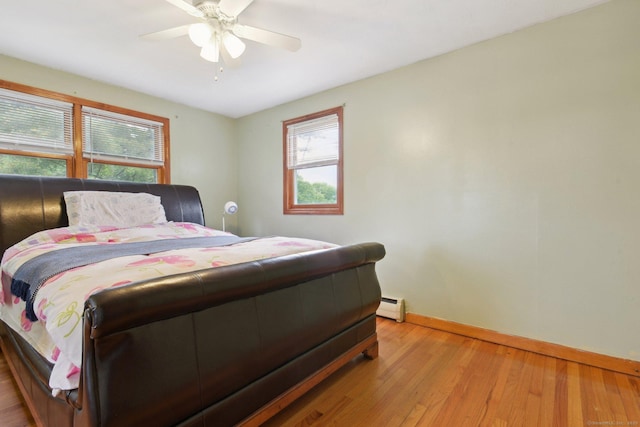 6 Royal Oaks Dr, Ledyard, CT 06339 - bedroom featuring baseboard heating, multiple windows, baseboards, and light wood-type flooring