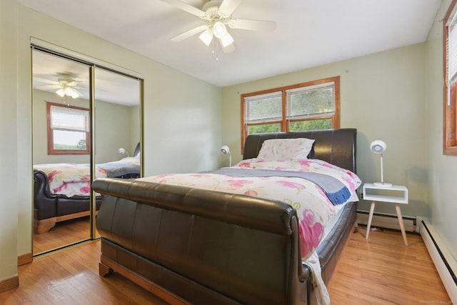 6 Royal Oaks Dr, Ledyard, CT 06339 - bedroom with baseboard heating, light wood-style floors, multiple windows, and a closet
