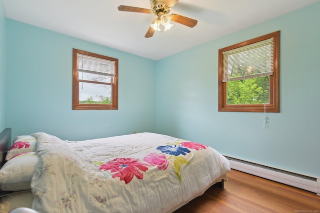 6 Royal Oaks Dr, Ledyard, CT 06339 - bedroom featuring a baseboard heating unit, wood finished floors, and a ceiling fan
