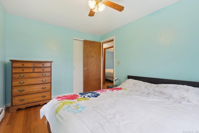 6 Royal Oaks Dr, Ledyard, CT 06339 - bedroom featuring wood finished floors, a closet, ceiling fan, and a baseboard radiator
