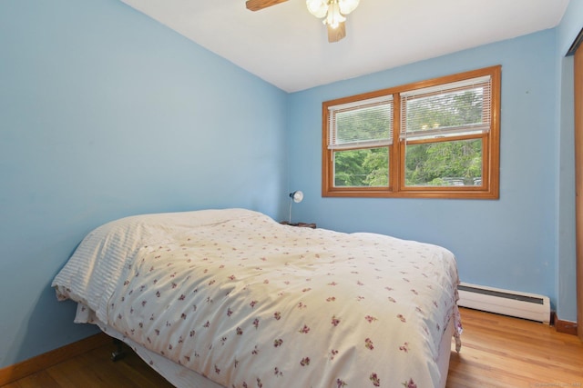 6 Royal Oaks Dr, Ledyard, CT 06339 - bedroom featuring a baseboard heating unit, baseboards, wood finished floors, and ceiling fan