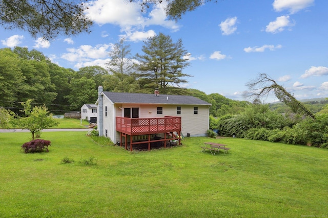 6 Royal Oaks Dr, Ledyard, CT 06339 - rear view of house with a wooden deck, a lawn, a chimney, and a wooded view