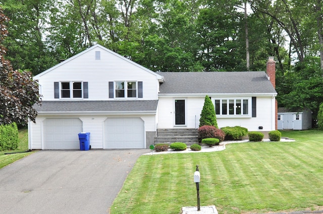 59 Settlers Knl, Newington, CT 06111 - tri-level home featuring an attached garage, driveway, a front lawn, a chimney, and view of wooded area