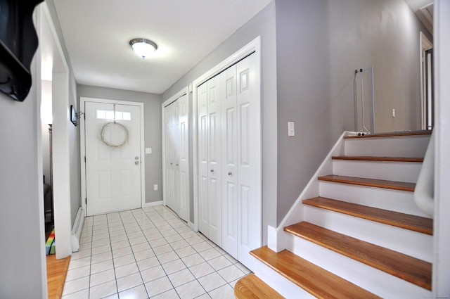 59 Settlers Knl, Newington, CT 06111 - entrance foyer with light tile patterned flooring, stairs, and baseboards