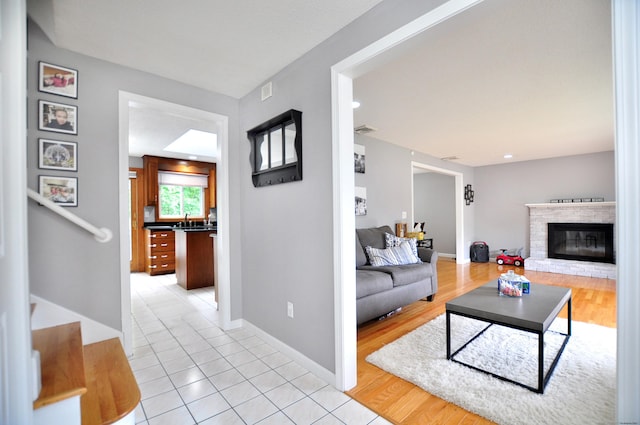59 Settlers Knl, Newington, CT 06111 - living area featuring a glass covered fireplace, stairs, baseboards, and light tile patterned floors