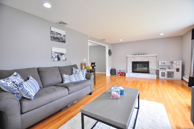 59 Settlers Knl, Newington, CT 06111 - living room featuring a baseboard radiator, light wood-style flooring, recessed lighting, and a glass covered fireplace