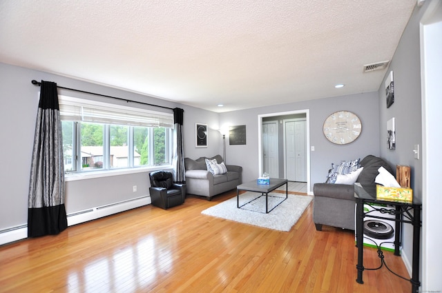 59 Settlers Knl, Newington, CT 06111 - living room with baseboard heating, wood finished floors, a textured ceiling, baseboards, and recessed lighting