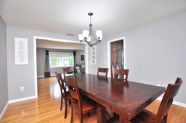 59 Settlers Knl, Newington, CT 06111 - dining area with a chandelier, light wood-type flooring, and baseboards