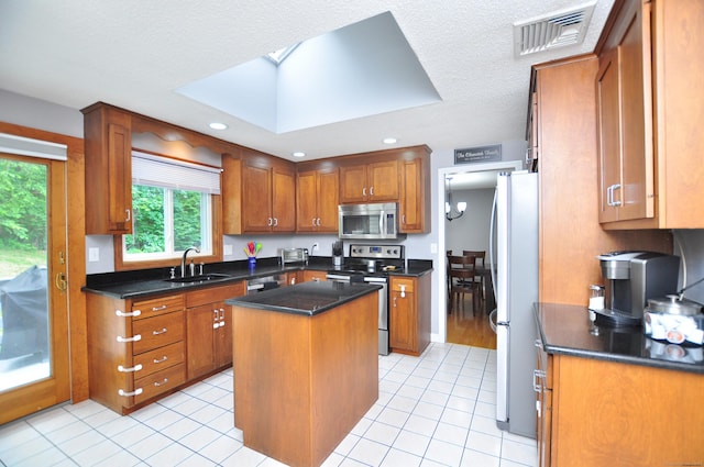 59 Settlers Knl, Newington, CT 06111 - kitchen with appliances with stainless steel finishes, a sink, brown cabinetry, dark countertops, and recessed lighting