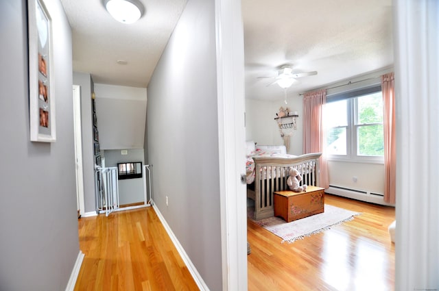 59 Settlers Knl, Newington, CT 06111 - hall featuring a baseboard heating unit, wood finished floors, and baseboards