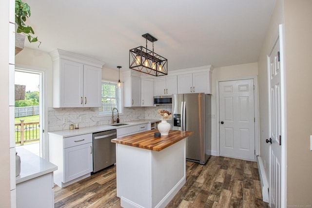 527 Highland Ave, Torrington, CT 06790 - kitchen with stainless steel appliances, butcher block countertops, a sink, decorative backsplash, and dark wood finished floors