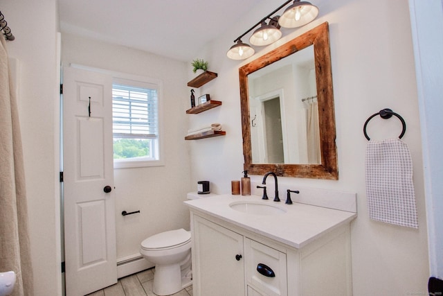527 Highland Ave, Torrington, CT 06790 - bathroom with a baseboard heating unit, vanity, and toilet