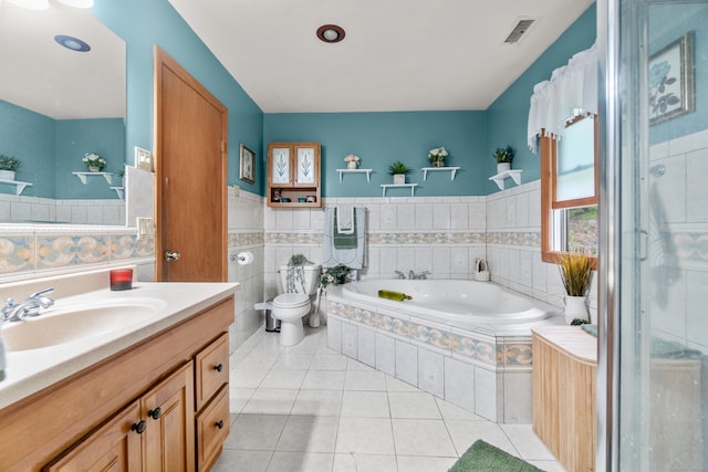 30 Hi Barlow Rd, Newtown, CT 06470 - bathroom with a garden tub, vanity, tile patterned floors, a shower stall, and tile walls