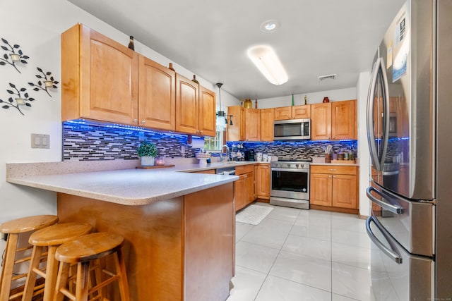 30 Hi Barlow Rd, Newtown, CT 06470 - kitchen with appliances with stainless steel finishes, a peninsula, backsplash, a kitchen bar, and light marble finish floors