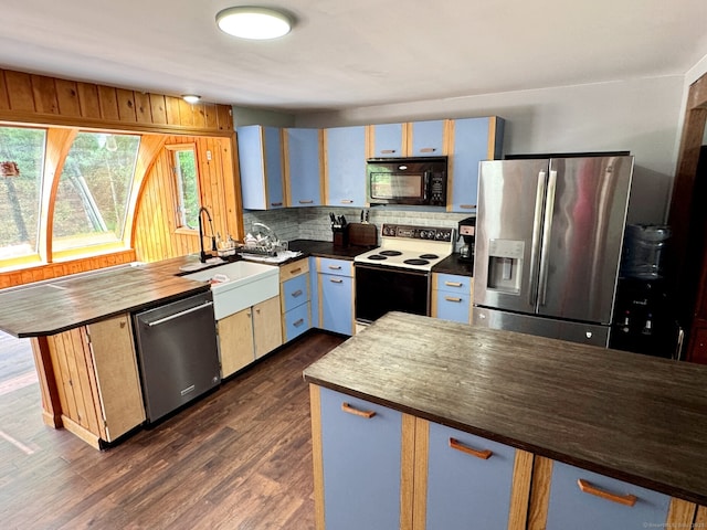 83 Shingle Mill Rd, Harwinton, CT 06791 - kitchen featuring stainless steel appliances, a peninsula, a sink, tasteful backsplash, and dark wood-style flooring