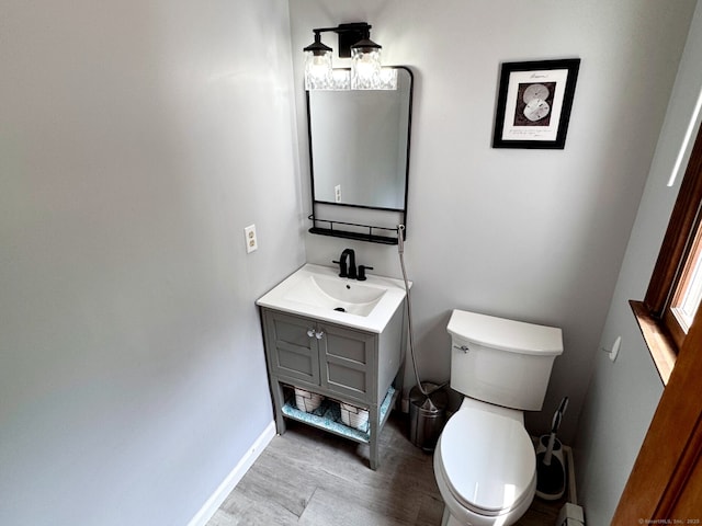 83 Shingle Mill Rd, Harwinton, CT 06791 - half bath with vanity, toilet, wood finished floors, and baseboards