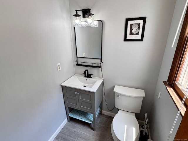 83 Shingle Mill Rd, Harwinton, CT 06791 - half bath with vanity, wood finished floors, and a chandelier