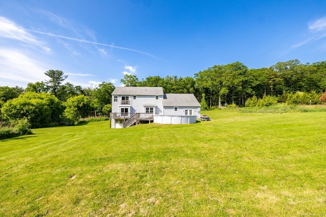 25 Cotton Bridge Rd, Killingly, CT 06241 - back of house with a wooden deck, stairway, a lawn, and a wooded view