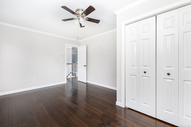 25 Cotton Bridge Rd, Killingly, CT 06241 - unfurnished bedroom featuring baseboards, crown molding, dark wood-style flooring, a closet, and ceiling fan