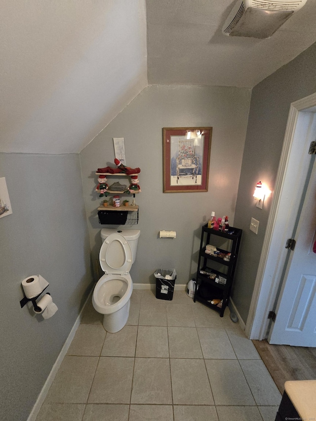 54 Lombard St, New Haven, CT 06513 - bathroom featuring vaulted ceiling, toilet, tile patterned flooring, and baseboards