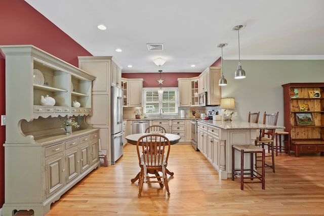 227 Meadow St, Shelton, CT 06484 - kitchen featuring stainless steel appliances, a peninsula, a breakfast bar area, light wood finished floors, and glass insert cabinets