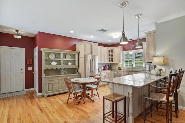 227 Meadow St, Shelton, CT 06484 - kitchen with appliances with stainless steel finishes, a peninsula, a kitchen breakfast bar, open shelves, and light stone countertops