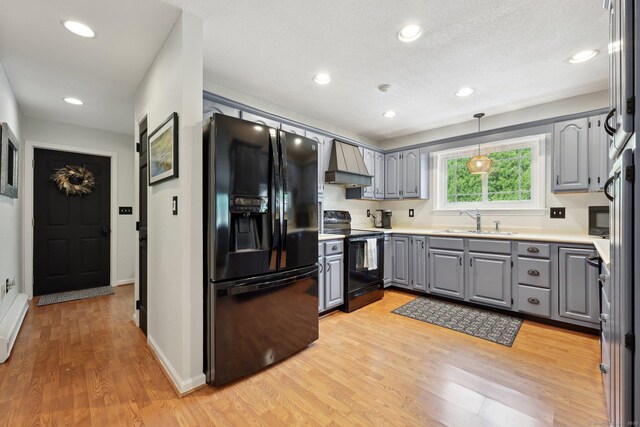 1 Spinnaker Rd, Waterford, CT 06385 - kitchen featuring black appliances, gray cabinetry, custom exhaust hood, a sink, and light wood-type flooring