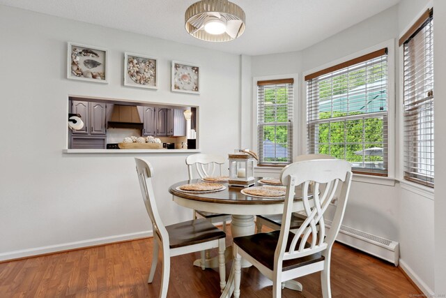 1 Spinnaker Rd, Waterford, CT 06385 - dining room featuring a baseboard radiator, baseboards, and wood finished floors