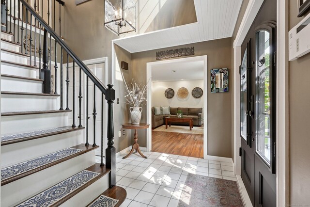 1 Spinnaker Rd, Waterford, CT 06385 - foyer with plenty of natural light, stairway, baseboards, and tile patterned floors